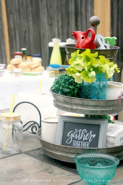 A vase of flowers sitting in a galvanized tub as a party organizer.